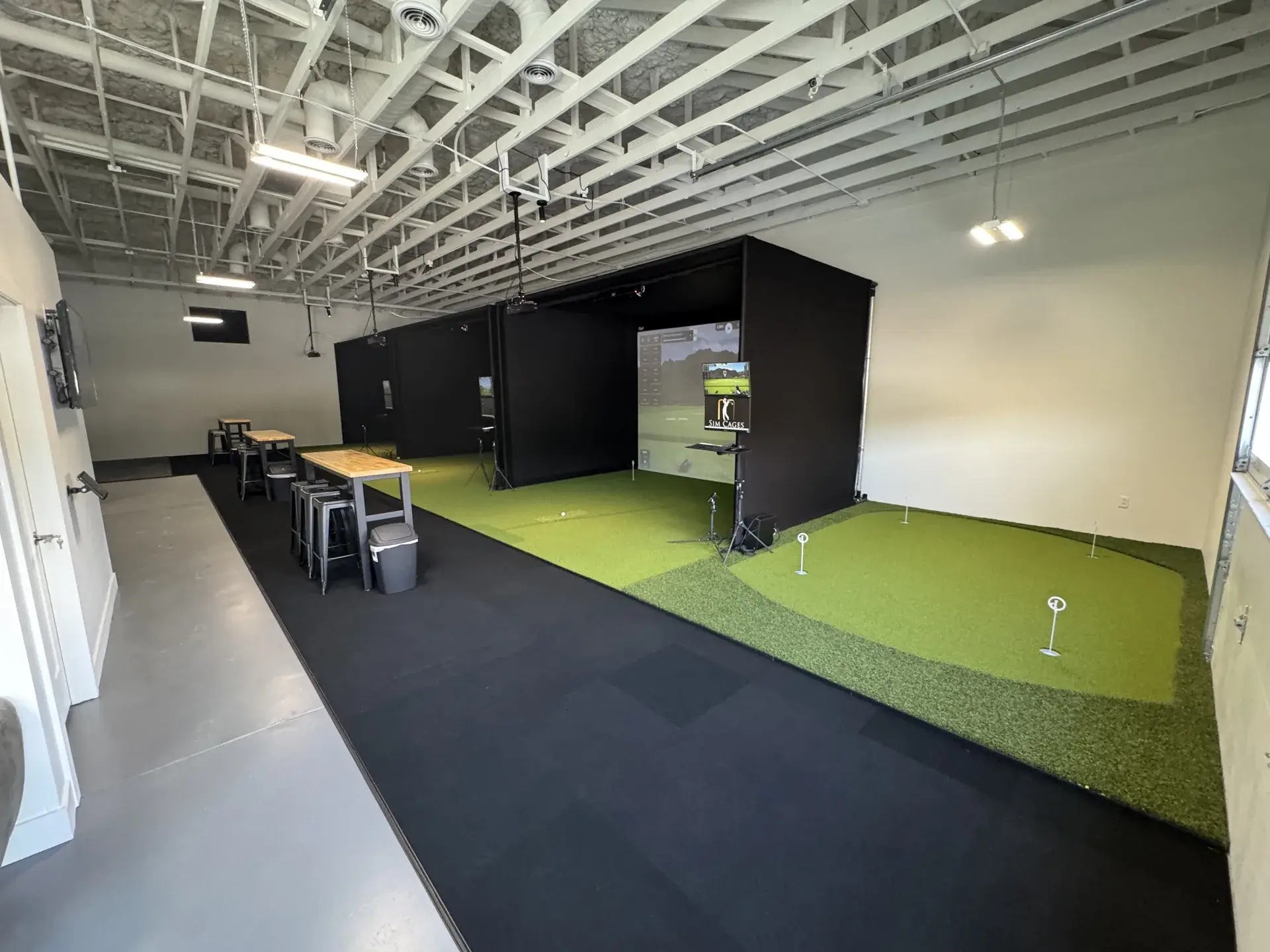 Putting green beside the simulator bays at Summit Golf Lab
